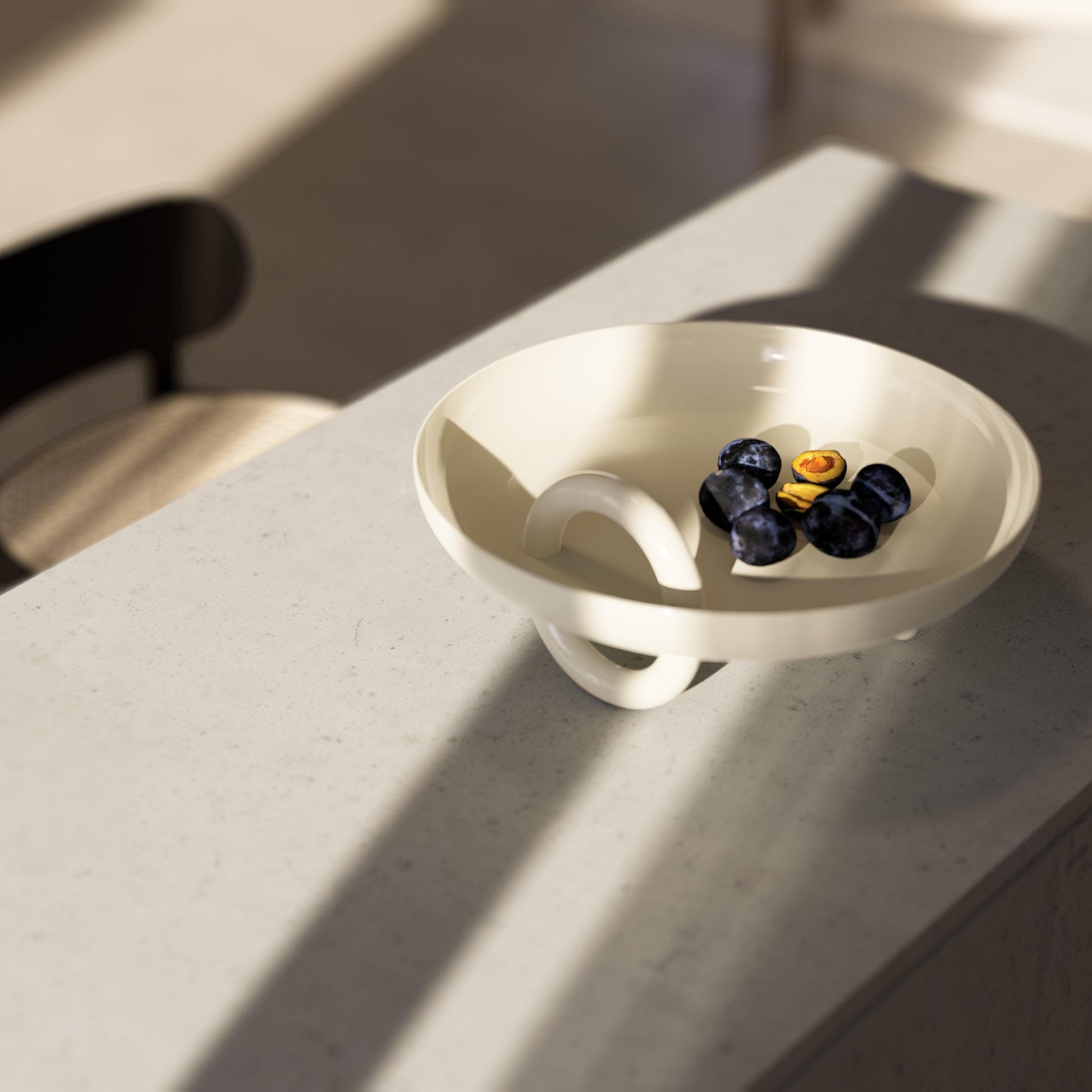 Atilio ceramic centerpiece placed on a living room table, adding a touch of elegant design - Mason Editions